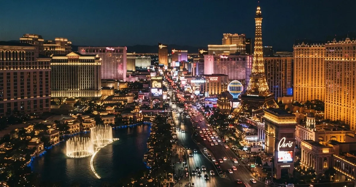 Una veduta aerea notturna della Strip di Las Vegas con le facciate illuminate dei casinò e degli hotel a tema
